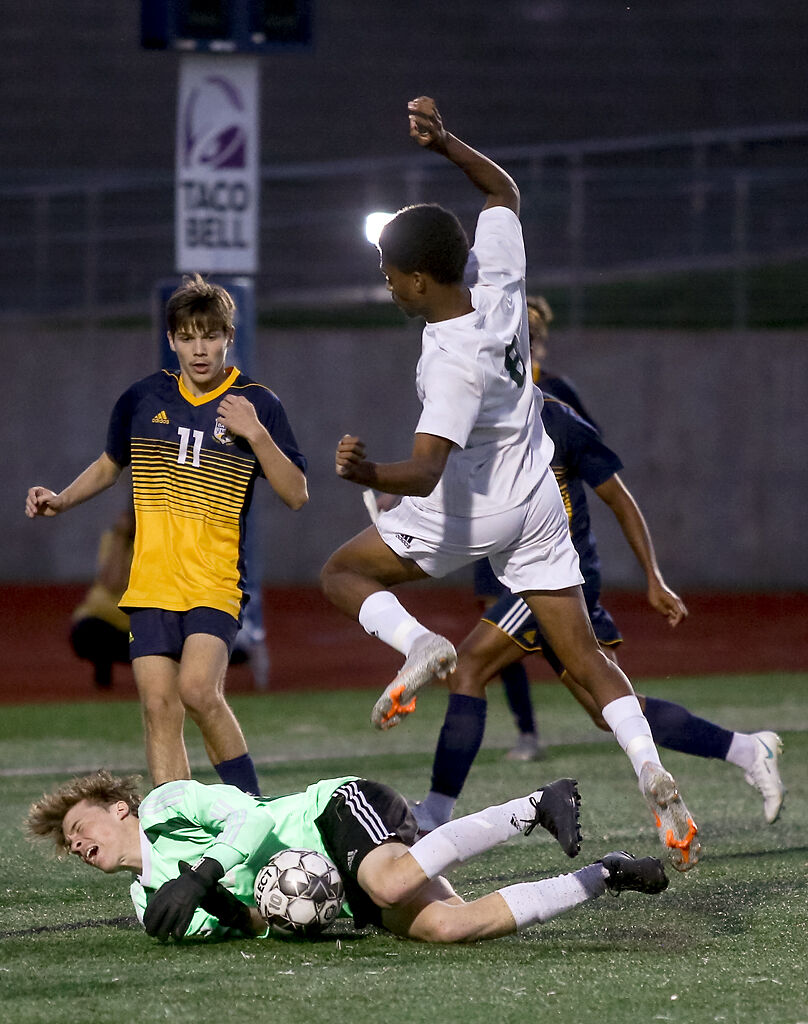 Rock Bridge senior Jeremiah Johnson jumps over Battle junior